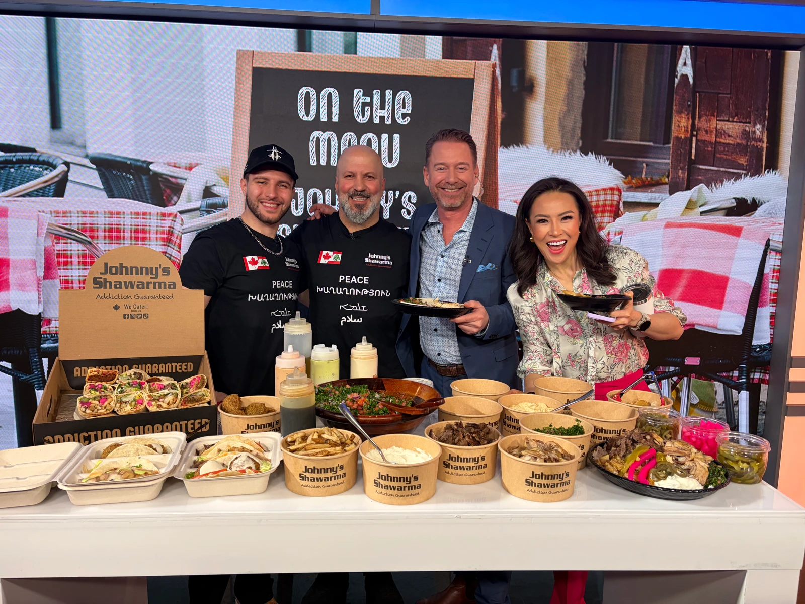 Johnny’s team with a spread of shawarma, wraps, falafel, salads and sauces