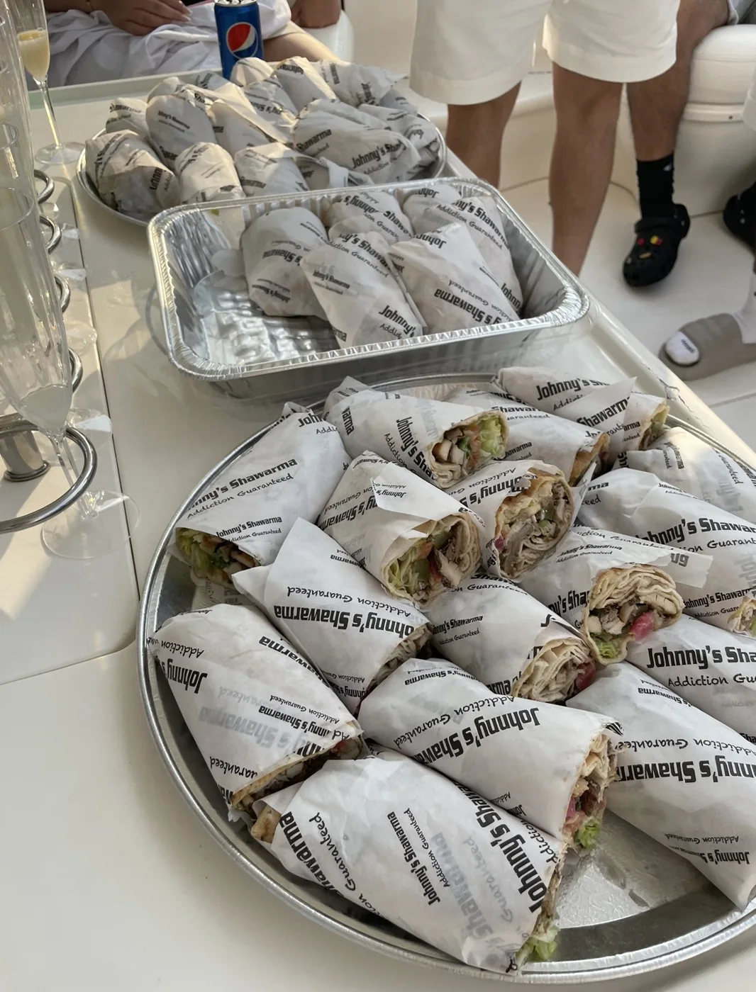 Platters and trays of wrapped shawarma for a gathering